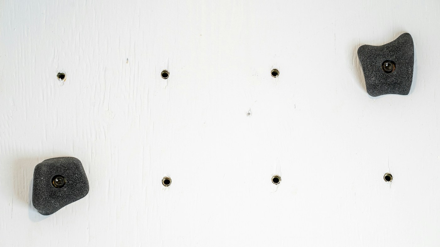 Climbing holds on a textured indoor wall